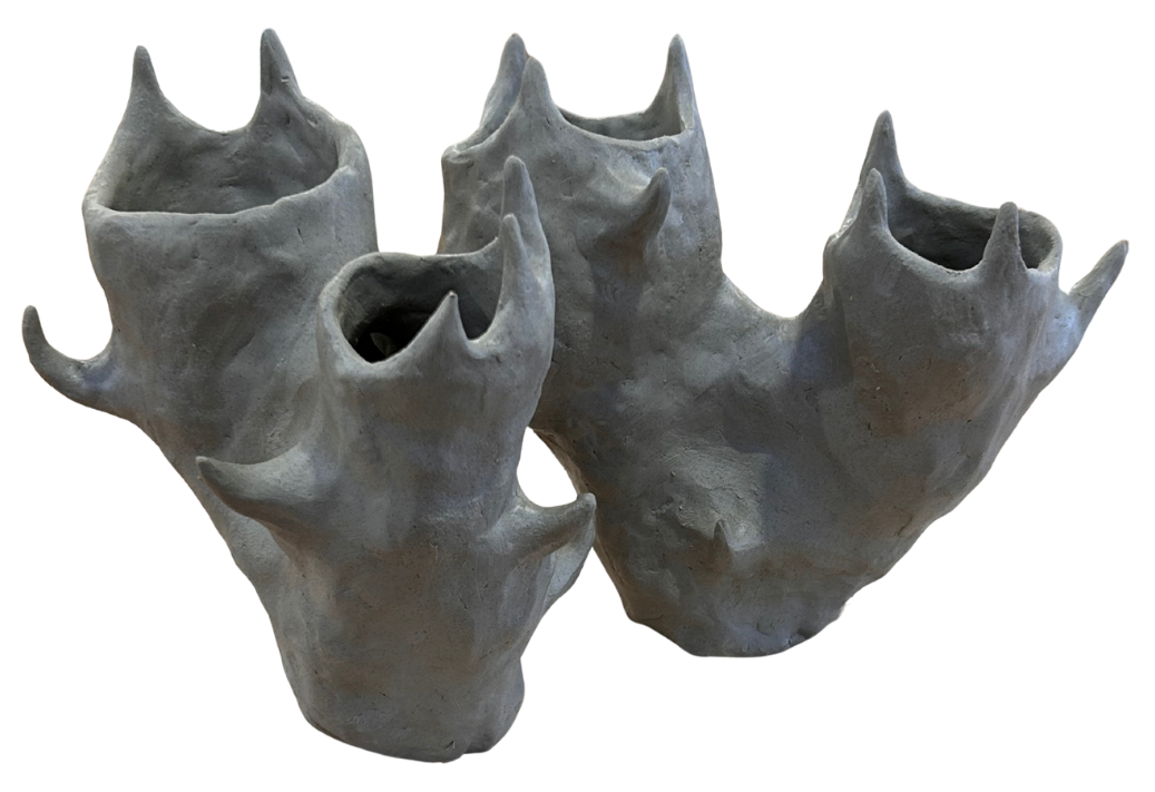 greenware clay vase with an organic shape, almost sea creature like with spikes.